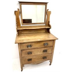 Art Nouveau oak three drawer dressing chest, raised mirror back, single shelf, three graduating drawers, shaped apron, stile supports on casters