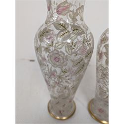 Pair of glass vases, of baluster form, painted with floral and foliate decoration, with gilt base and rim, H27.8cm