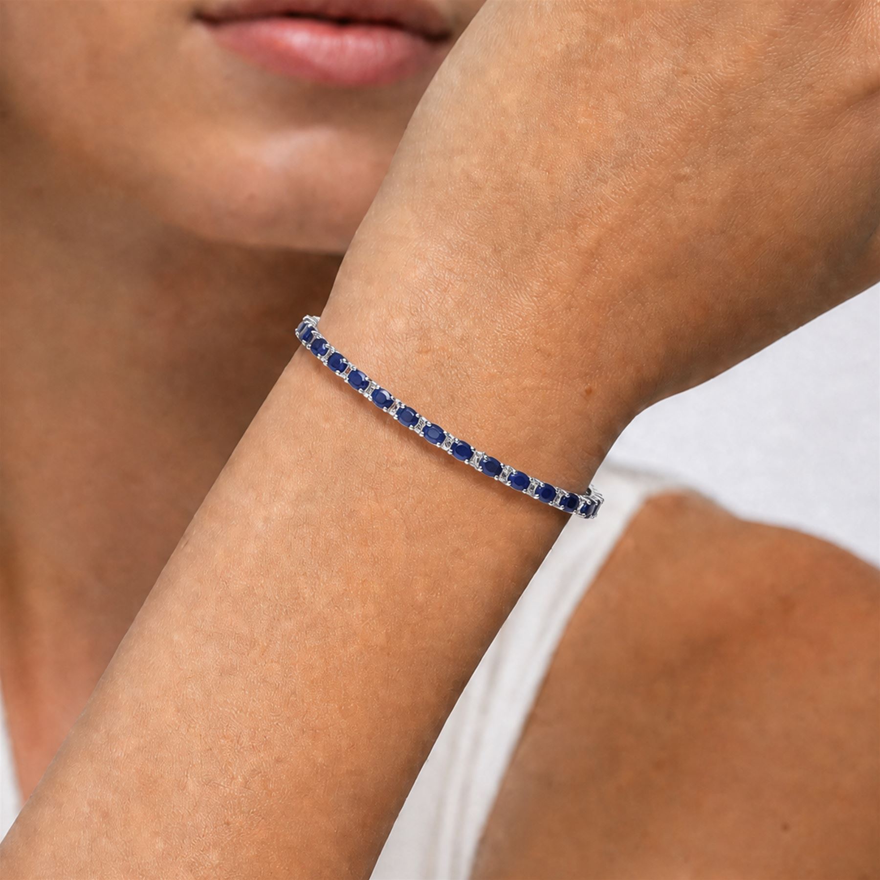 18ct white gold sapphire and diamond bracelet, twenty-six oval cut sapphires, each spaced by two round brilliant cut diamonds, stamped 750, total sapphire weight 10.60 carat, total diamond weight 0.46 carat