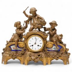 French-late 19th century gilt and spelter mantle clock, highly decorative case with two Sevres style porcelain panels to the front and surmounted with three figures of children playing musical instruments, white enamel dial with Roman numerals and steel moon hands, two train countwheel strike movement, striking the hours and half hours on a bell. With key and pendulum.    