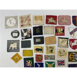 Approximately one-hundred printed and embroidered cloth badges including I, II, VIII, XI, XII and XXX Corps, Eastern Command, various Armoured Divisions, Midland, Wessex, Home Counties and 12th Infantry Brigades, Salisbury Plain, Northumberland, Hampshire, North Midland, West Riding, Essex and Suffolk Districts, Berlin & Rhine Army Troops etc