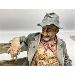 Two Capodimonte figures, comprising The Watchmaker by Curiase and Tramp Seated on a Bench, created by D.Bonalberti, tallest example H24cm