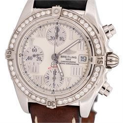 Breitling Chrono Cockpit gentleman's stainless steel diamond set automatic wristwatch, Ref. A13357, serial No. 2084732, cream dial with Roman numeral hour markers and date aperture, diamond set unidirectional rotating bezel, on Breitling brown leather strap, with fold-over clasp
