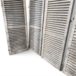 Five 19th century full height French Chateau louvre doors, pitch pine painted in cream finish, two having iron rod hinges, dimensions approx.