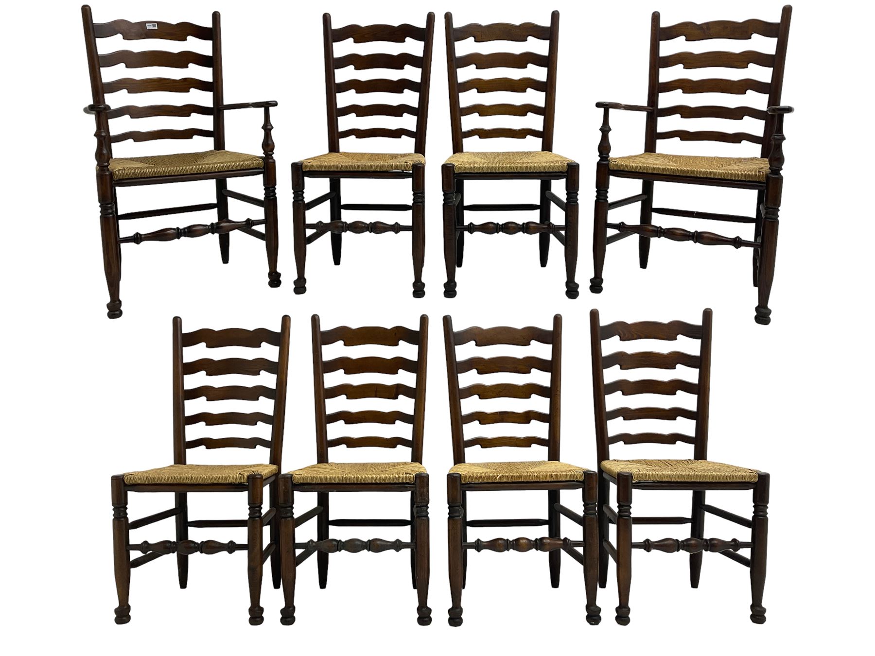 Set eight (6+2) oak dining chairs, high waived ladder back over rush seats, raised on ring turned supports with pad front feet, united by stretchers