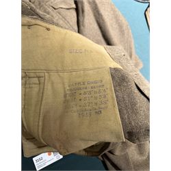 WWII British parachute regiment battle dress uniform, the jacket with shoulder title and Pegasus formation badge to the left arm, shoulder title, Pegasus formation badge and cloth wings to the right, size 3 dated 1943, the trousers size 3 dated 1945 