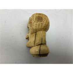 19th century carved ivory walking cane handle, modelled as the head of a greyhound with inset glass eyes, together with a further 19th century ivory example, modelled as a caricature of a gentleman's head, (2)