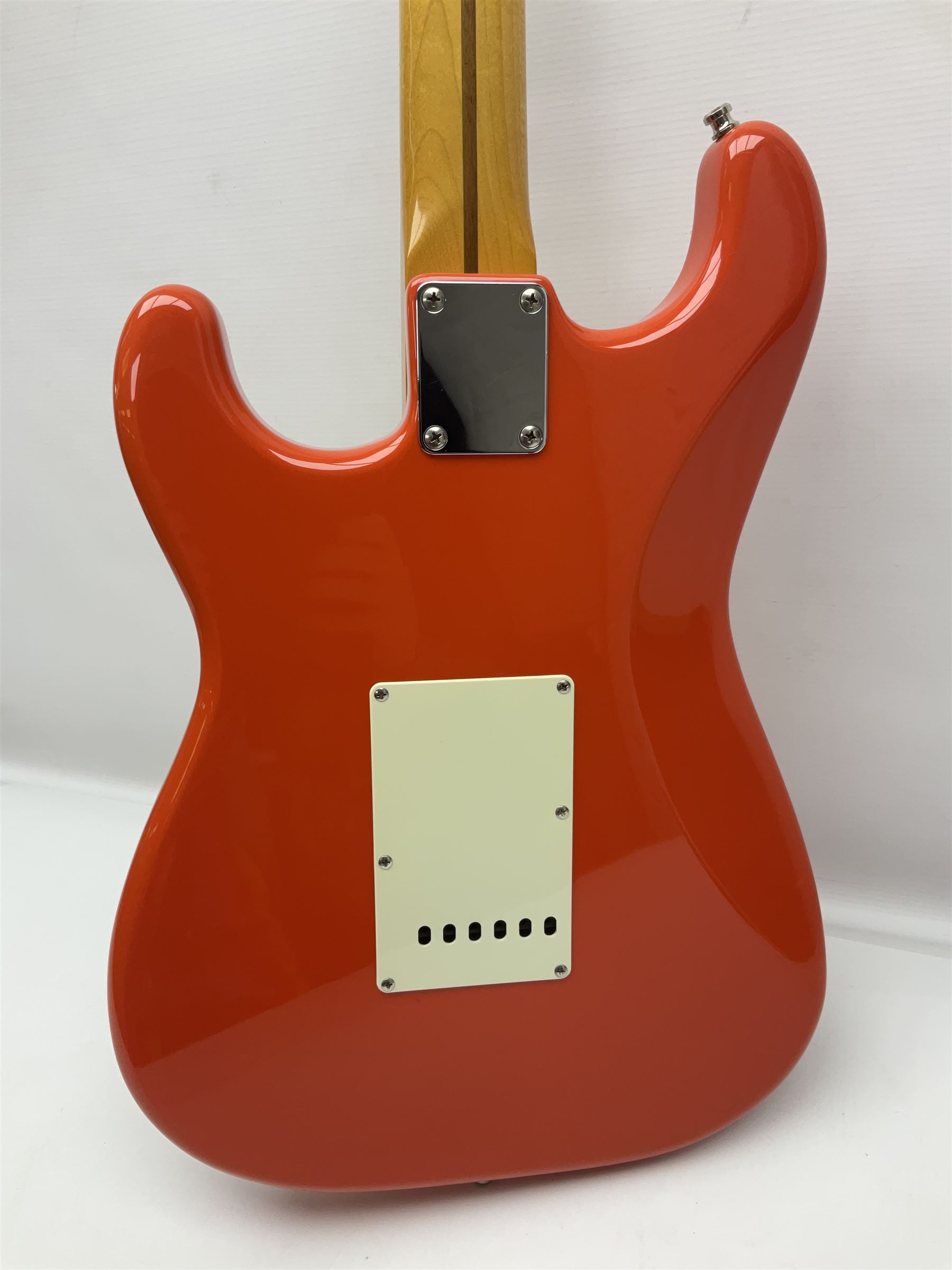 Japanese Squier Fender 'Hank Marvin' Stratocaster electric guitar, c1992, in Fiesta red with tremolo arm and facsimile signature decal; serial no.L037281, L98cm; in hard carrying case.