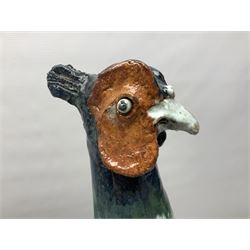 Large stoneware sculpture modeled as a Ring Neck Pheasant, upon a naturalistic base, H55cm, L78cm