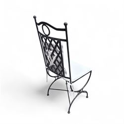 Wrought steel rectangular conservatory dining table, with glass top; and six, four side and two armchairs, with lattice backs and X framed bases, loose cushions