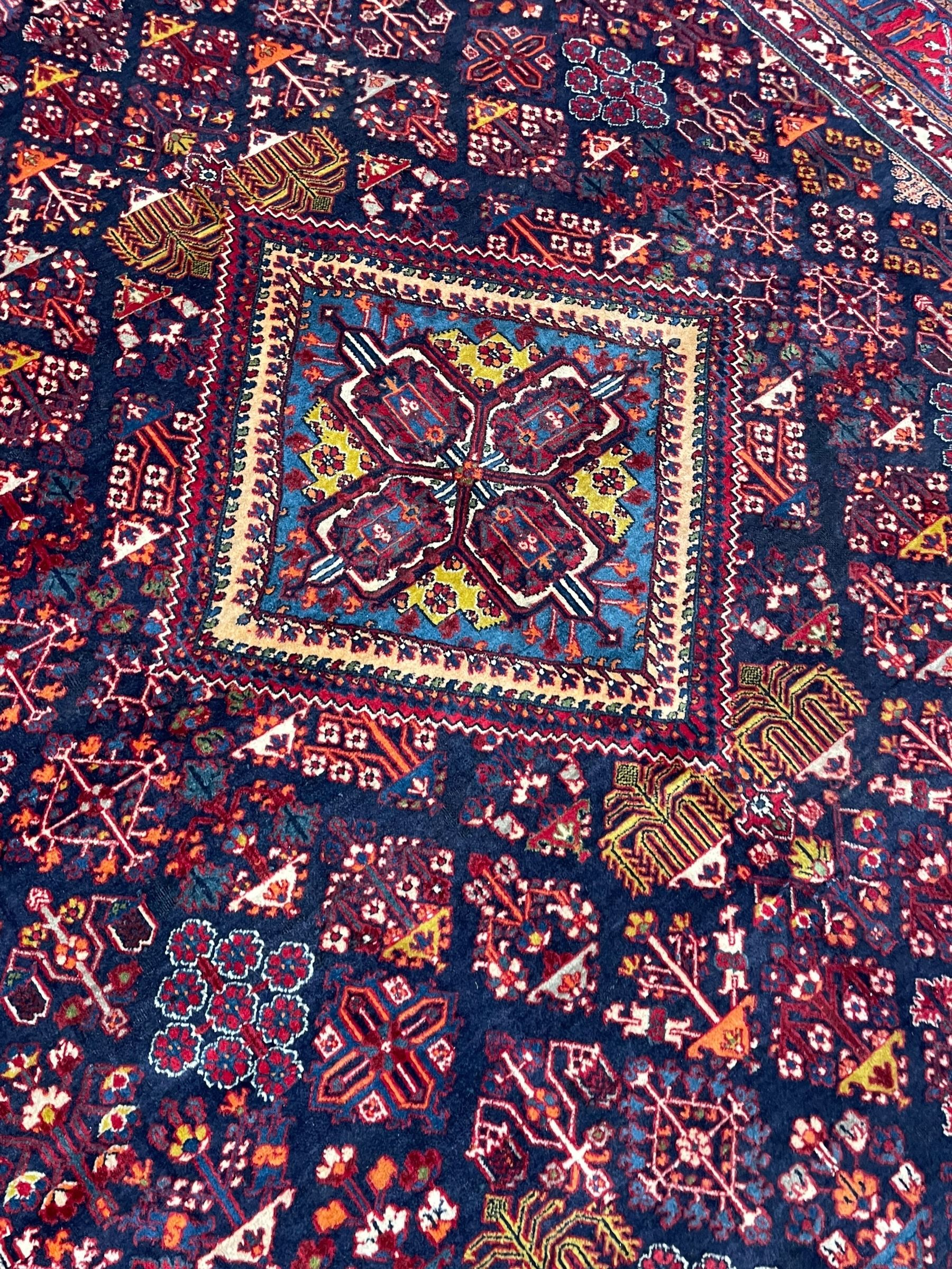 Persian Meimeh indigo ground rug, the central medallion within a field of small floral lozenge motifs, the guarded border with repeating pattern