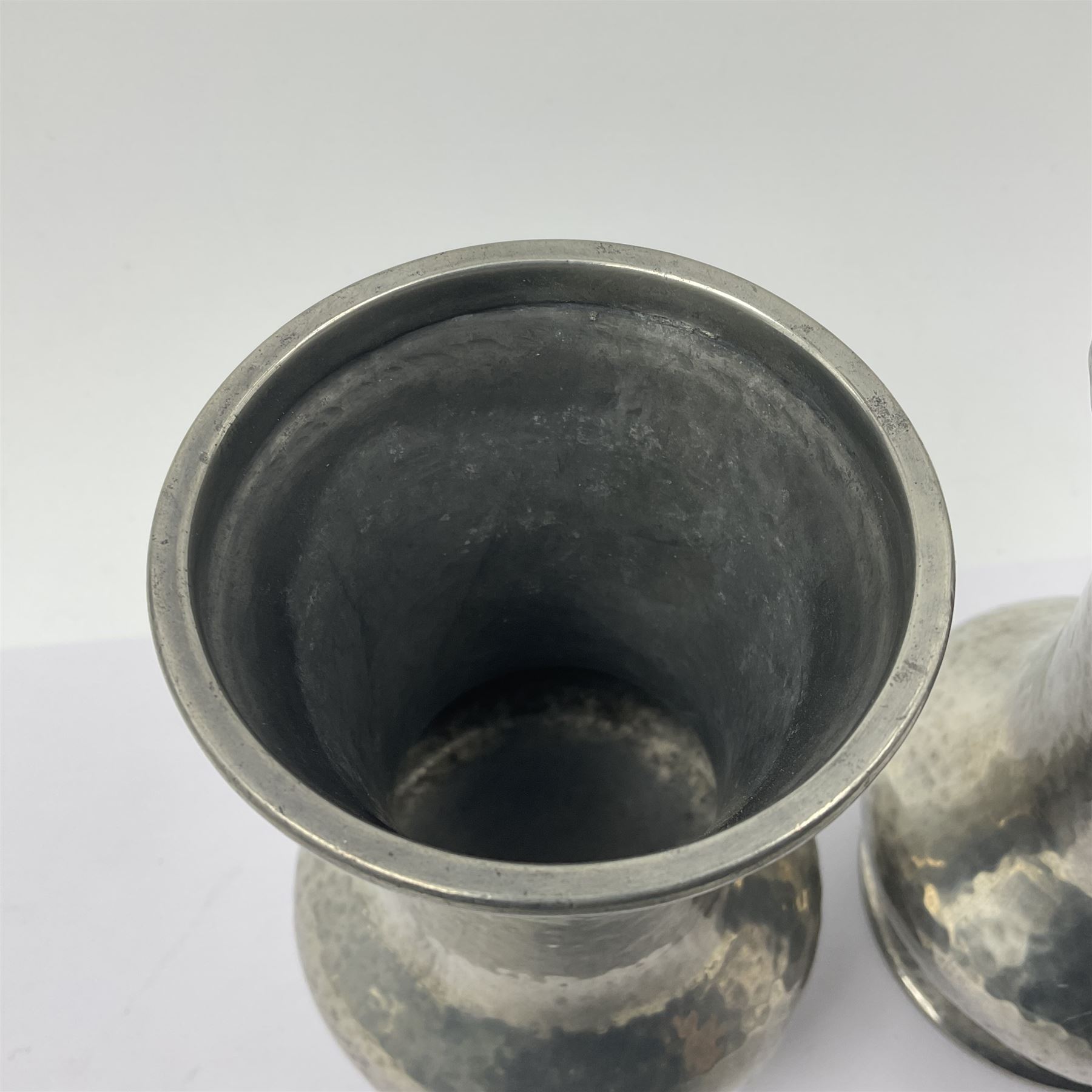 Pair of Liberty & Co Tudric pewter vases, each of bellied form with hammered finish, upon a circular spreading foot, impressed beneath 0987, H12cm
