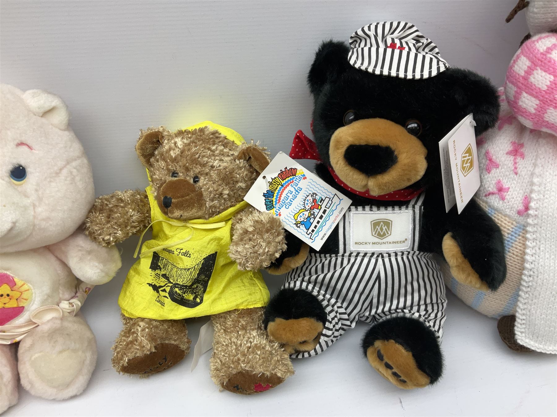 Ten soft tots including Chad Valley Lenny the Lion; Snoopy type dog; Fluffy Hedgehogs; pink Care Bear; souvenir bears for Niagara Falls, Benjamin Franklin and Andre Rieu; Rocky Mountaineer Traindriver; knitted Mrs. Tiggy-Winkle etc; all unboxed (10)