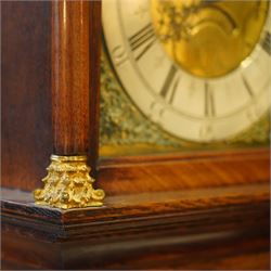 Gilbert Kidd of Malton-oak cased mid-18th century 30hr longcase clock, with a caddy top and three gesso finials, square hood door flanked by turned pilasters with Corinthian capitals, trunk with a long wavy topped door on a square plinth with an shaped skirt, brass dial with an engraved dial centre, date aperture and steal hands, silvered chapter ring with Roman numerals and five minute Arabic's, dial pinned to a chain driven countwheel striking movement. With a brass cased weight and pendulum. 