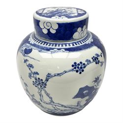Chinese blue and white ginger jar, painted with bamboo and blossoming trees in panels against a flowerhead ground, H24cm