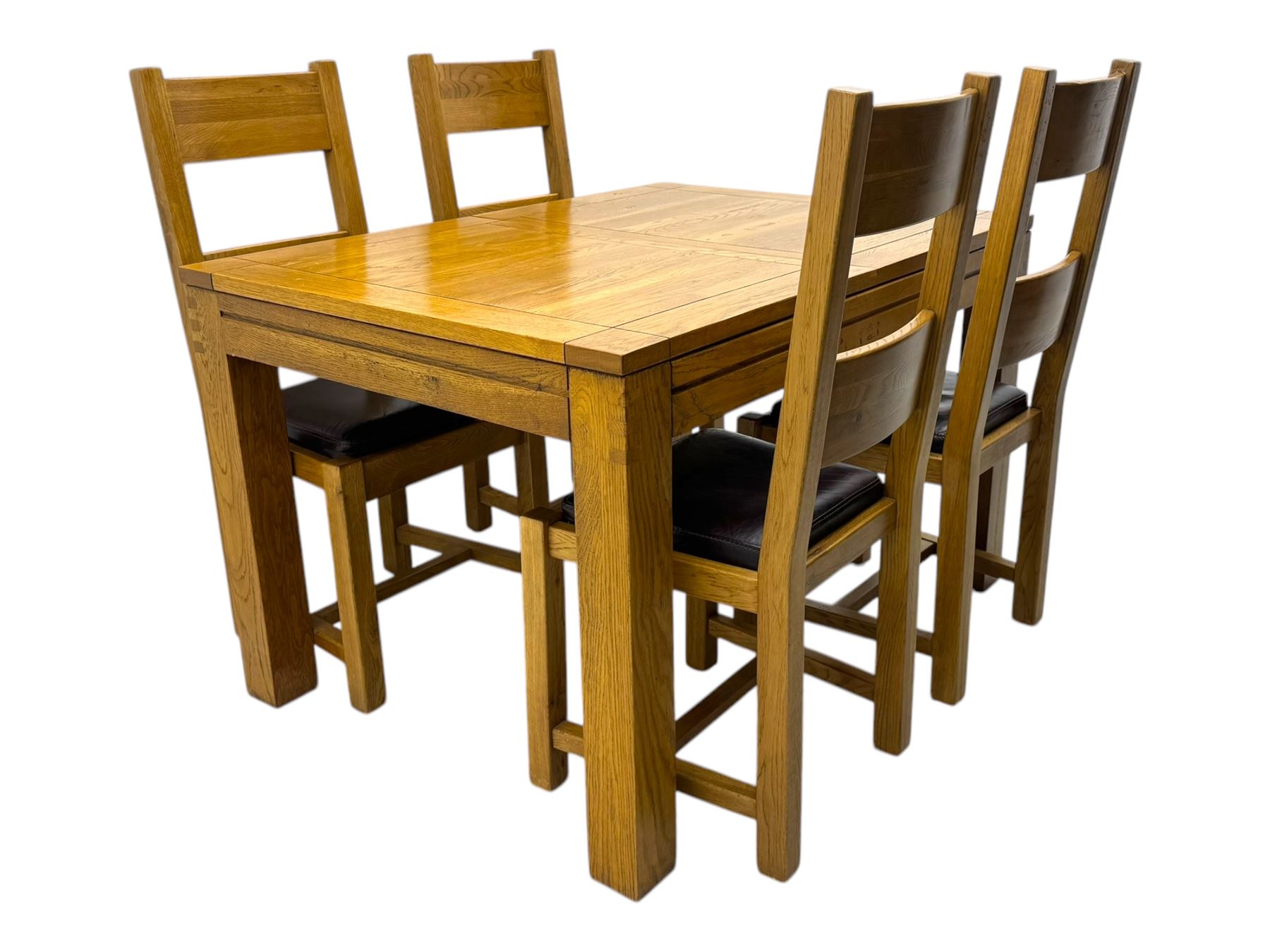 Contemporary oak dining table, rectangular panelled top with integral extension leaf, raised on square supports; set of four oak ladder-back chairs with padded brown seats