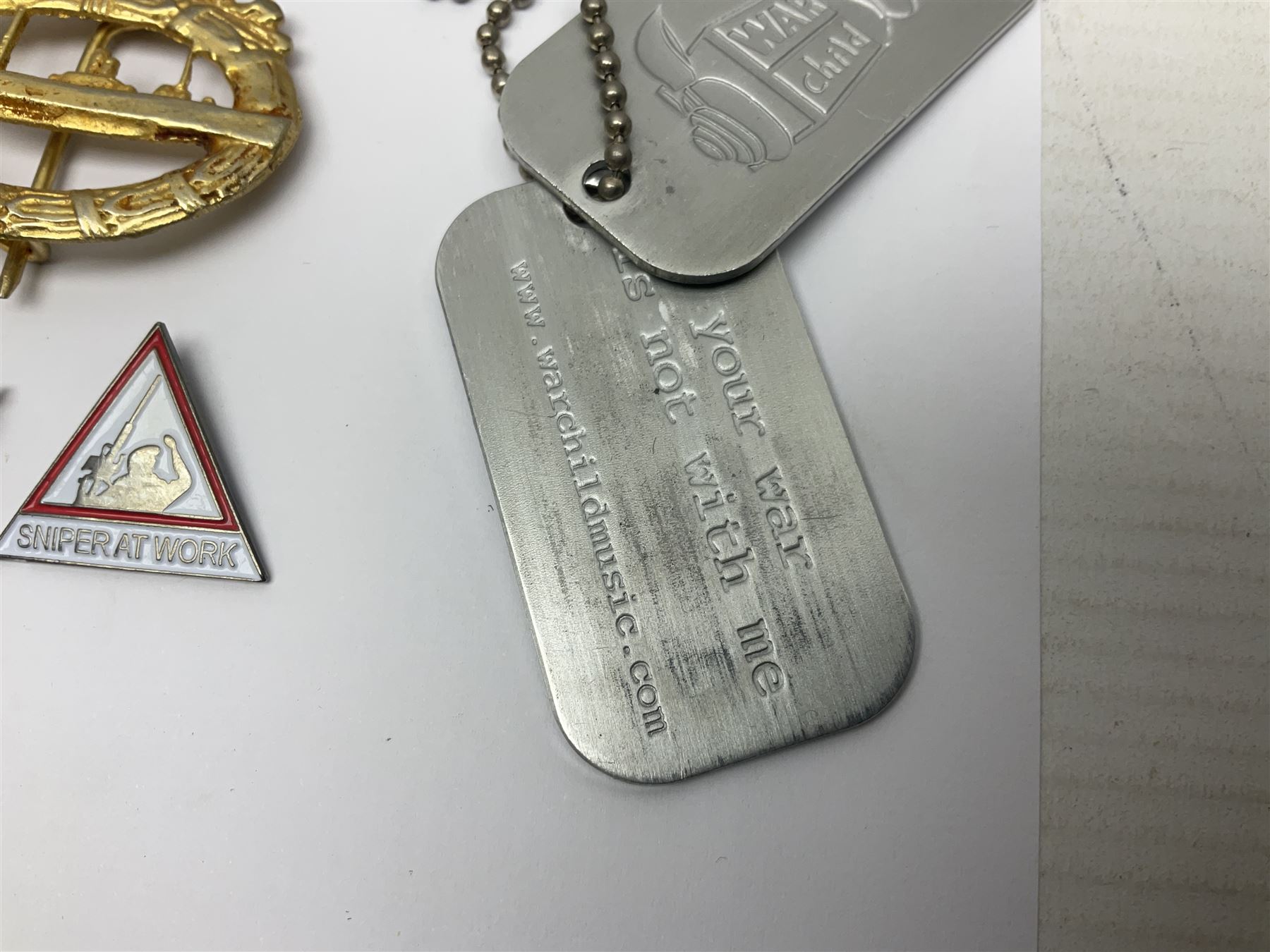 Two Edwardian hallmarked silver presentation fobs for military bugling competitions; and quantity of cap/glengarry and other badges, sweetheart brooches etc