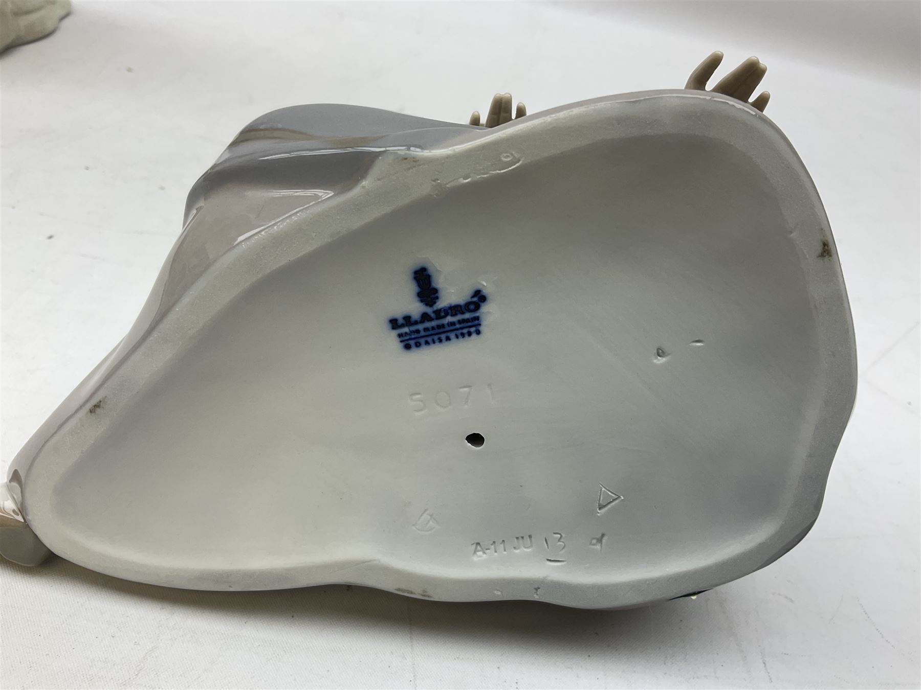 Four Lladro figures, comprising Afternoon Promenade no 7636, Nostalgia no 5071, both with original boxes, Girl with Lilies no 4972 and Madonna no 4534, largest example H27cm