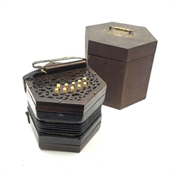  19th century rosewood concertina of hexagonal form with fretworked ends, twenty-one numbered bone keys and leather straps to each end, no visible maker's marks, W18cm, in original mahogany box with brass carrying handle  