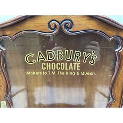Edwardian mahogany glazed wall cabinet, with black and gold Cadburys lettering to the hinged door, opening to reveal shelved interior, H64cm