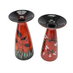 Two Poole Pottery vases decorated in Butterfly pattern, together with matching jug and another Poole Pottery vase decorated in cherry blossom