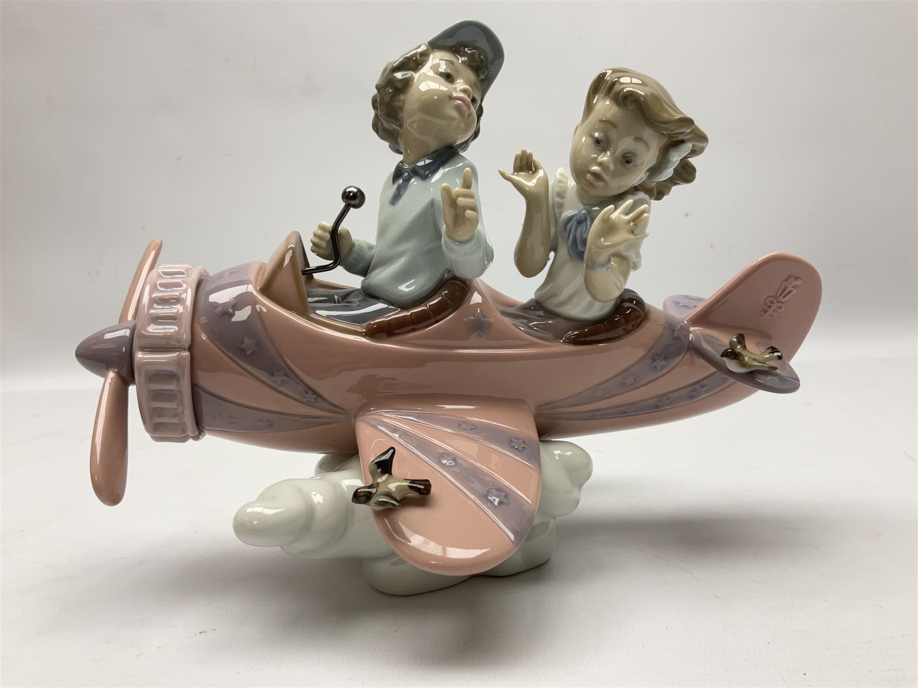 Lladro figure, Don't Look Down, modelled as a girl and boy in a plane, sculpted by Joan Coderch, no 5698, year issued 1990, year retired 2004, H17cm
