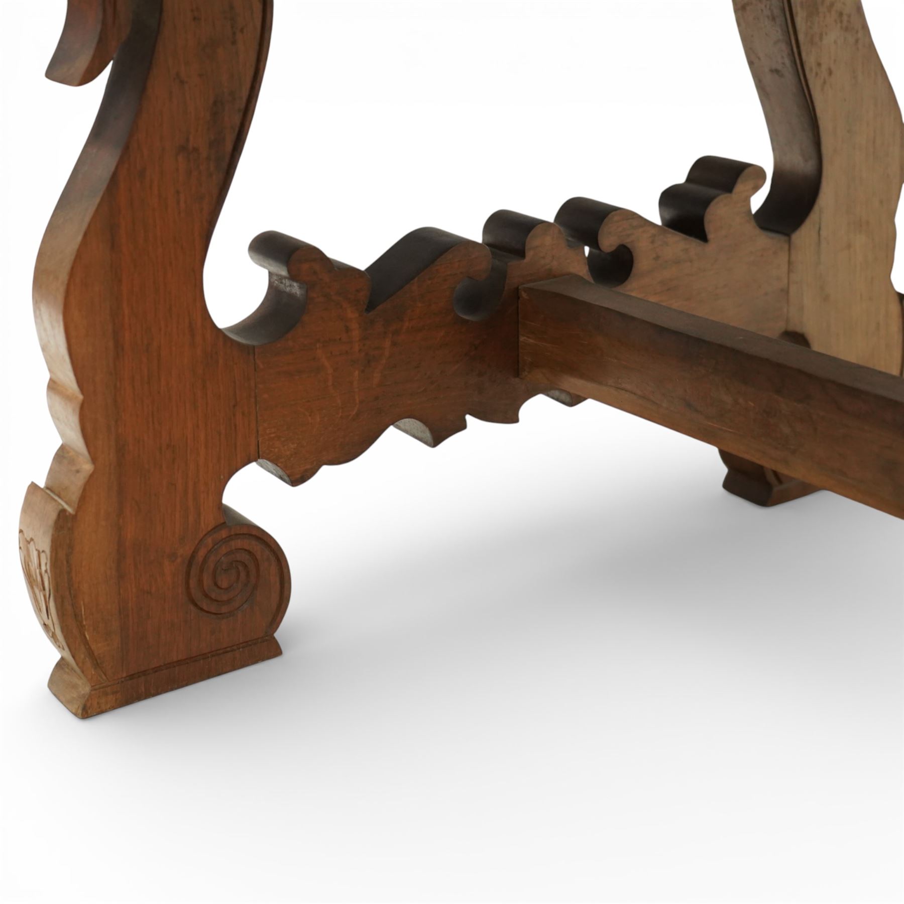 20th century Spanish design oak dining table, large rectangular top above a run of three drawers to the frieze, standing on shaped trestle supports with scroll cut details and stretcher base