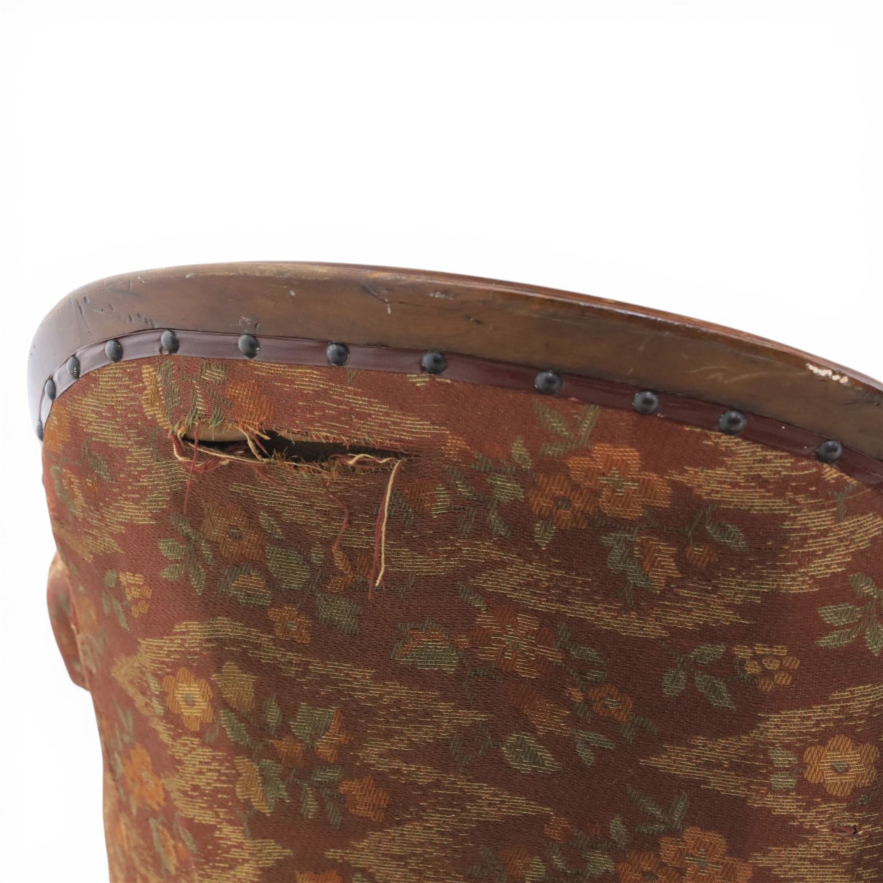 Victorian mahogany framed serpentine sofa, the shaped button upholstered back with central carved foliate cartouche, and scroll arms with carved terminals, over upholstered red seat, upon carved cabriole supports with castors