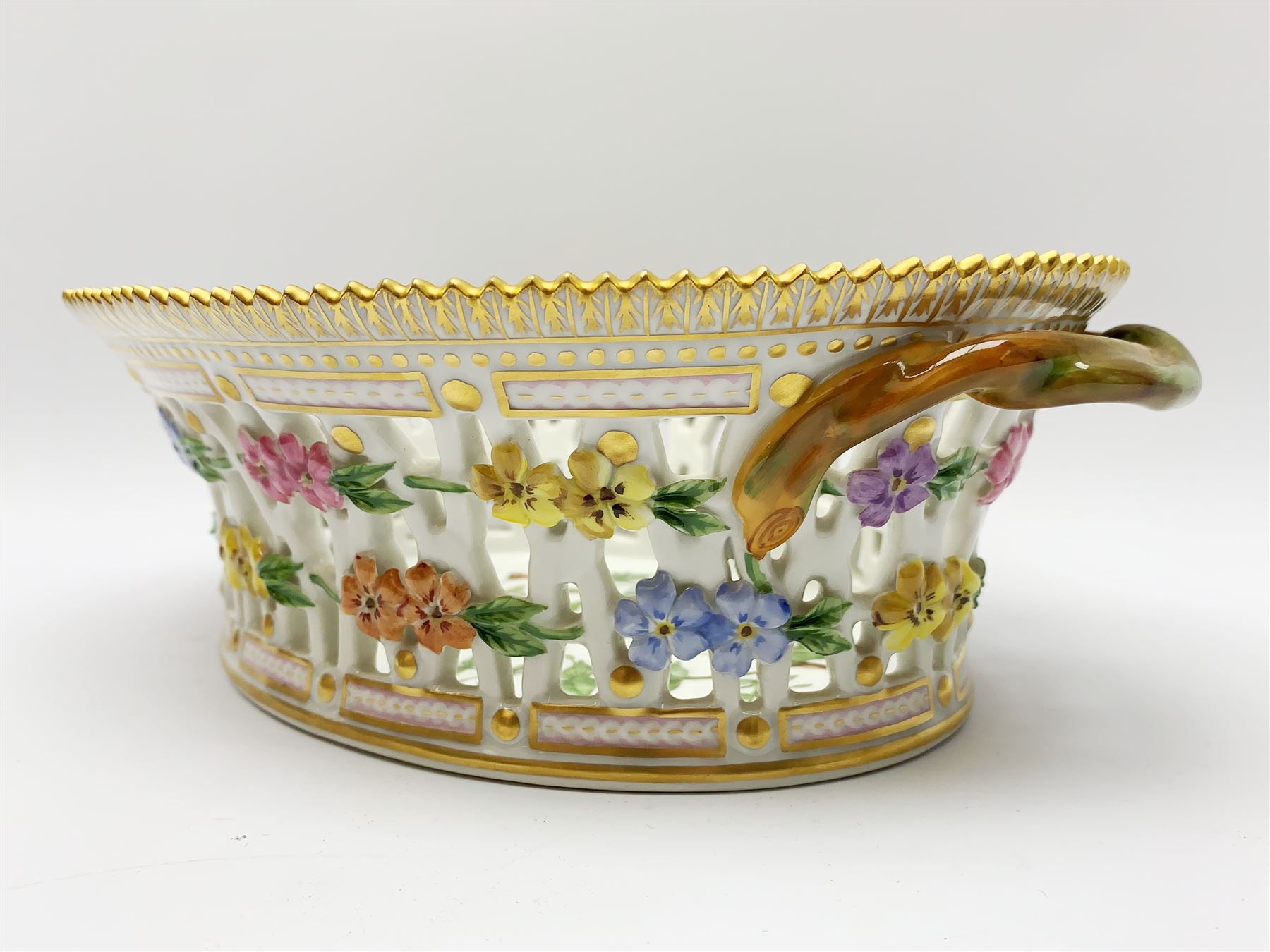 Royal Copenhagen Flora Danica basket, with naturalistically modelled vine handles and reticulated sides detailed with polychrome forget-me-nots, the interior decorated with a botanical study of 'Anagallis arvensis', sprigs and a gilt border, with printed and painted marks beneath, H8cm L26cm 

