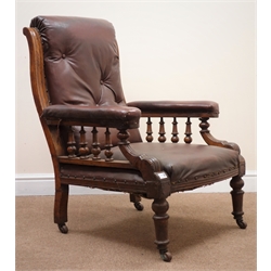  Late Victorian oak framed gentleman's armchair, upholstered in a maroon leather, turned tapering supports, W69cm  