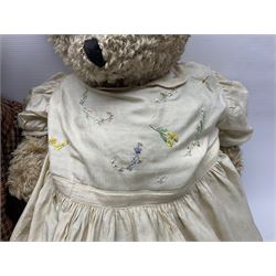 Two early 20th century straw filled jointed teddy bears, first example wearing a tweed jacket bearing Geoffrey Saville label, with leather padded paws and ears, horizontally stitched nose and humpback; second example with applied eyes, vertically stitched nose and faux leather paw pads, both with growler mechanisms, tallest H74cm 