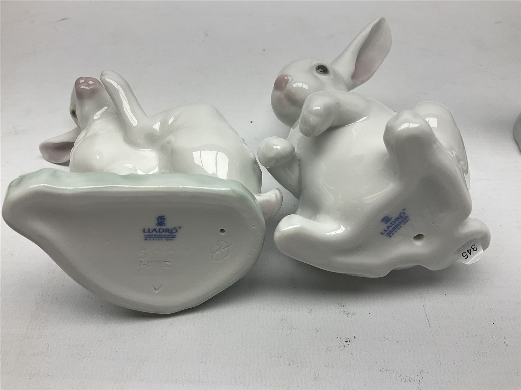 Four Lladro rabbit figures, comprising, Hippity Hop no 5886, Sitting Bunny no 5907, Washing up no 5887, and Rabbit Eating no 4773, largest example 14cm  