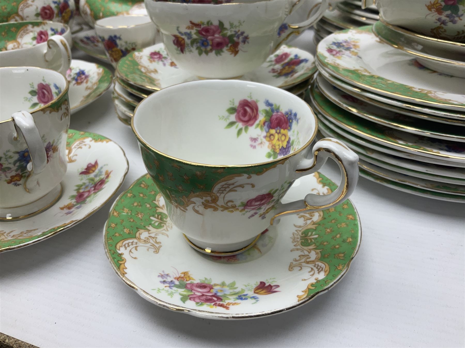 Paragon Rockingham pattern part tea and dinner service including three teapots, milk jug, cups and saucers of various sizes, ten soup bowls, ten side plates, ten dinner plates etc (96)