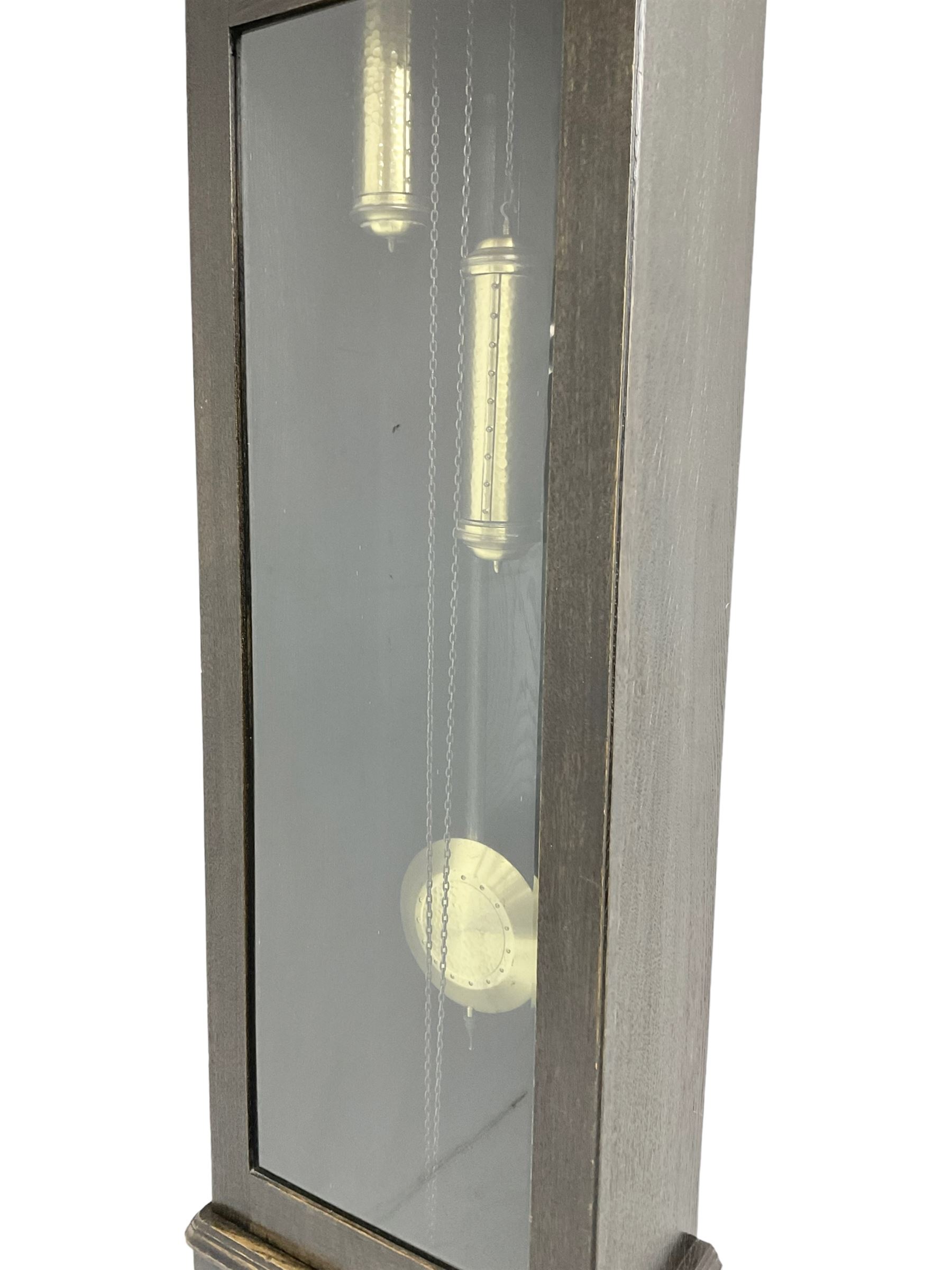 20th century Art Deco- oak cased 8-day longcase clock c1930, flat topped case with a fully glazed door on a stepped plinth, silvered circular dial with Arabic numerals and pierced steel hands, chain driven twin train movement with  4 gong rods. With pendulum and two brass cased weights.