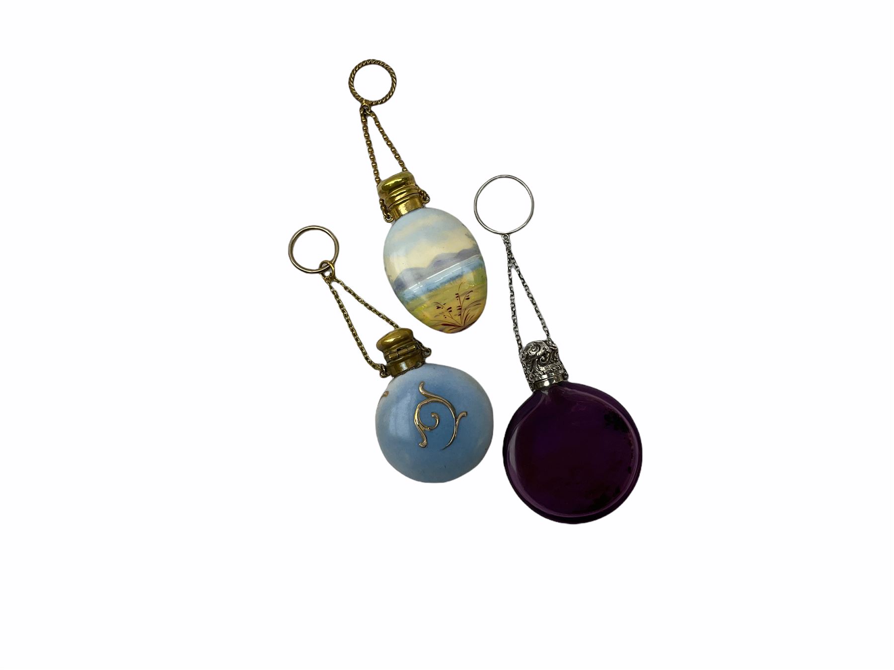 Cut glass perfume bottle of bellied form, the silver mounted cover with turquoise guilloche enamel top, hallmarked Henry Perkins & Sons, London 1927, together with a cut glass perfume bottle with silver mounted and yellow guilloche enamel lid, hallmarked Albert Carter, Birmingham 1950, Continental silver perfume bottle, of barrel form with embossed figural detail, stamped 930, scent bottle of bellied form with white metal foliate pierced overlay, amethyst glass scent bottle of flask form with foliate embossed white metal cover and suspension ring and chain, and three further examples, including one of ovoid form with painted decoration and silver cover, hallmarked for Birmingham.