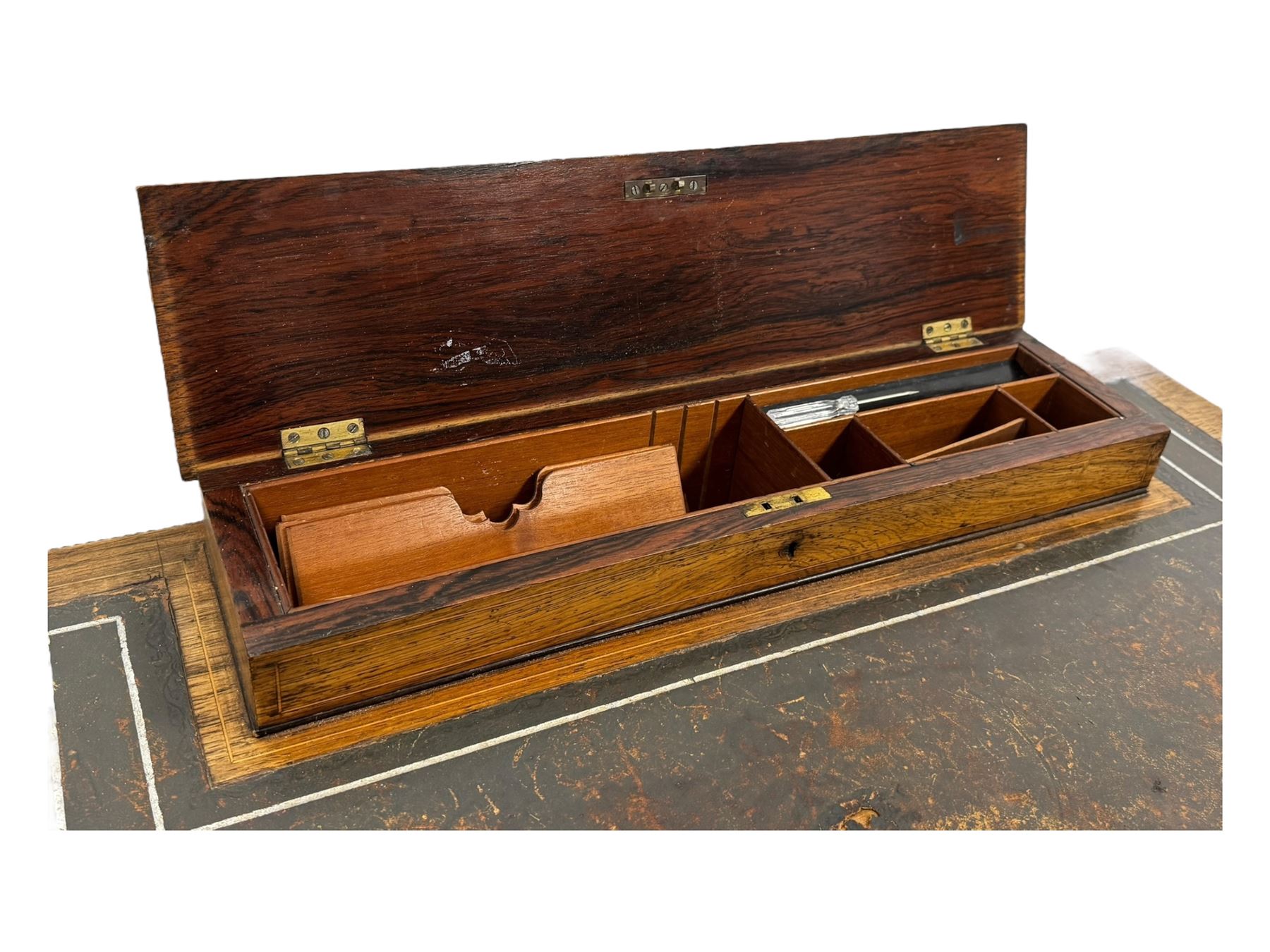 Late Victorian walnut writing table, rectangular leather-inset top surmounted by a brass gallery, fitted with a single frieze drawer, raised on turned tapering supports with lower undertier and ceramic castors