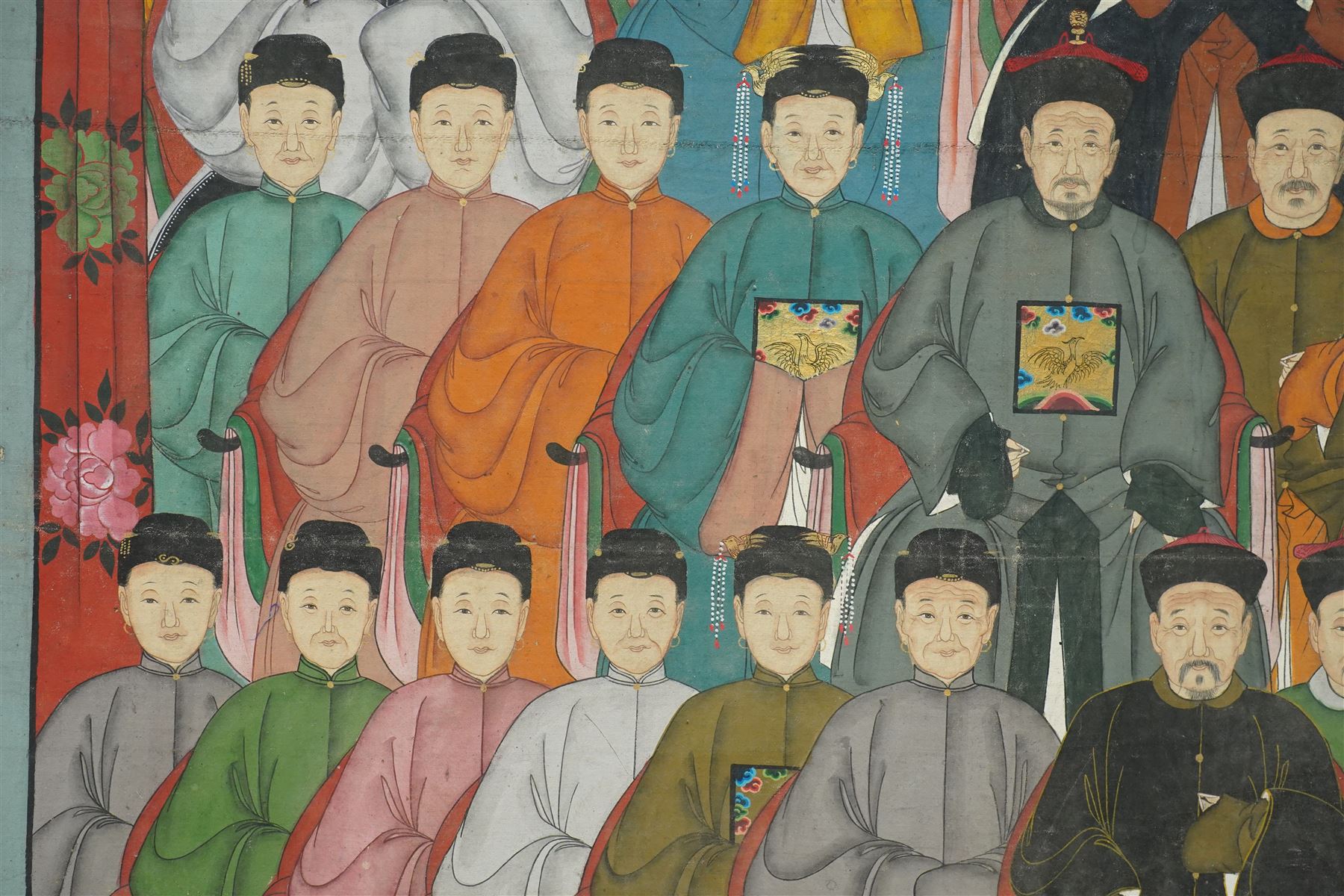 Large and impressive Chinese ancestral portrait, late Qing dynasty, gouache on stitched canvas with gilded highlights, showing thirty-eight sitters across four registers, the principal ancestors depicted before an altar table holding various ritual items, each in official dress and many wearing Golden Pheasant (Second-rank) and Silver Pheasant (Fifth-rank) Mandarin squares or 'buzi', overall 190cm x 131cm 