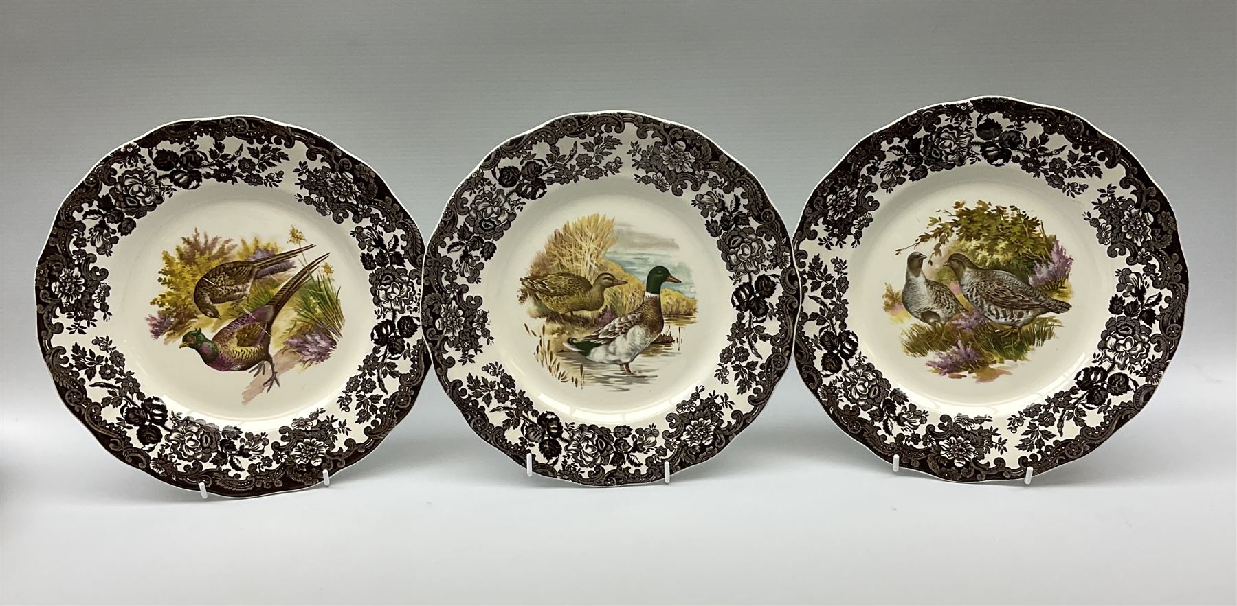 Royal Worcester Palissy Game Series pattern dinner wares, comprising seven dinner plates, six side plates, twelve bowls, sauce boat and stand, six tea cups, eight saucers, further larger saucer, milk jug, and open sucrier. 