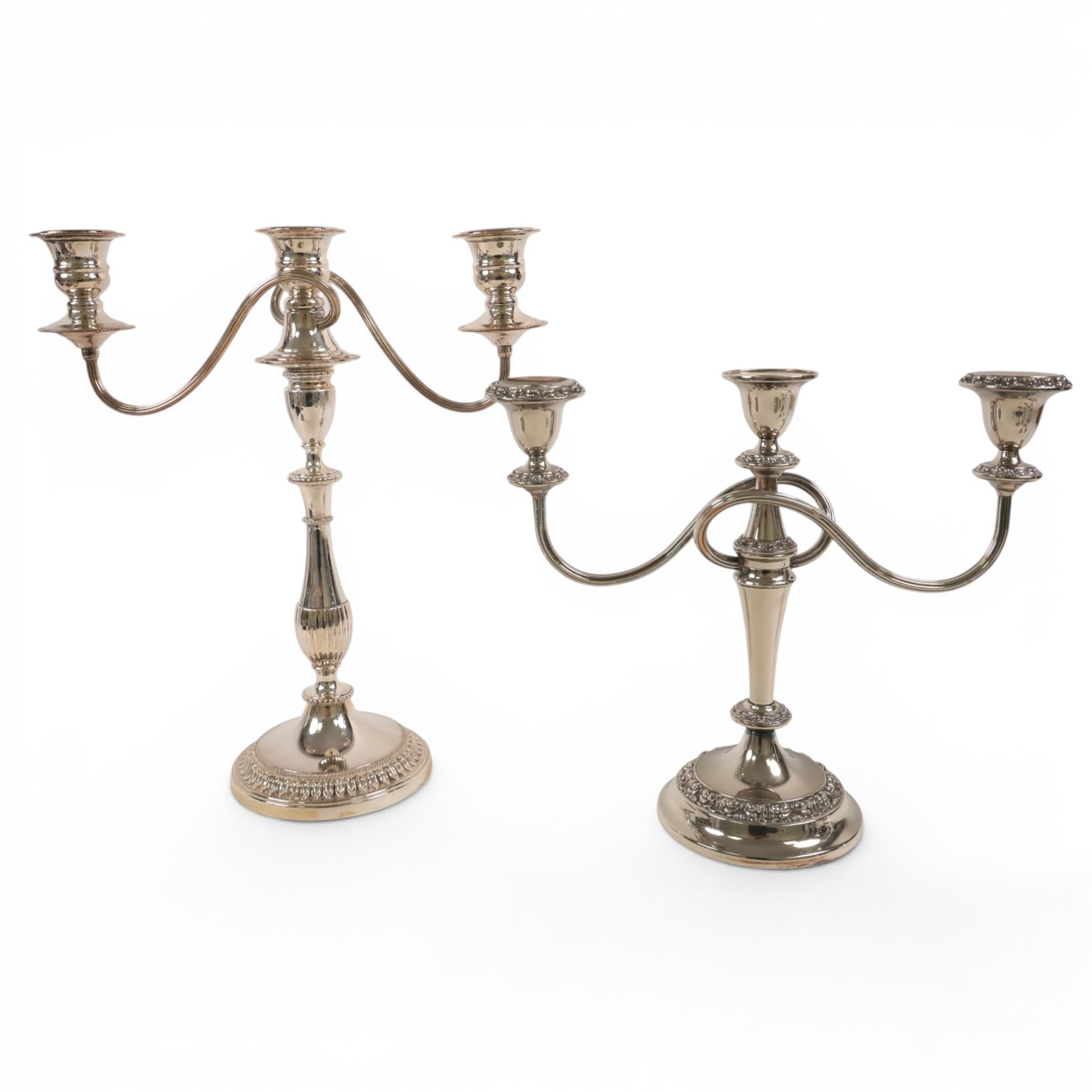 Silver plate two branch candelabra with grape vine decoration to the base, together with a matching pair of candle sticks and other candlesticks  