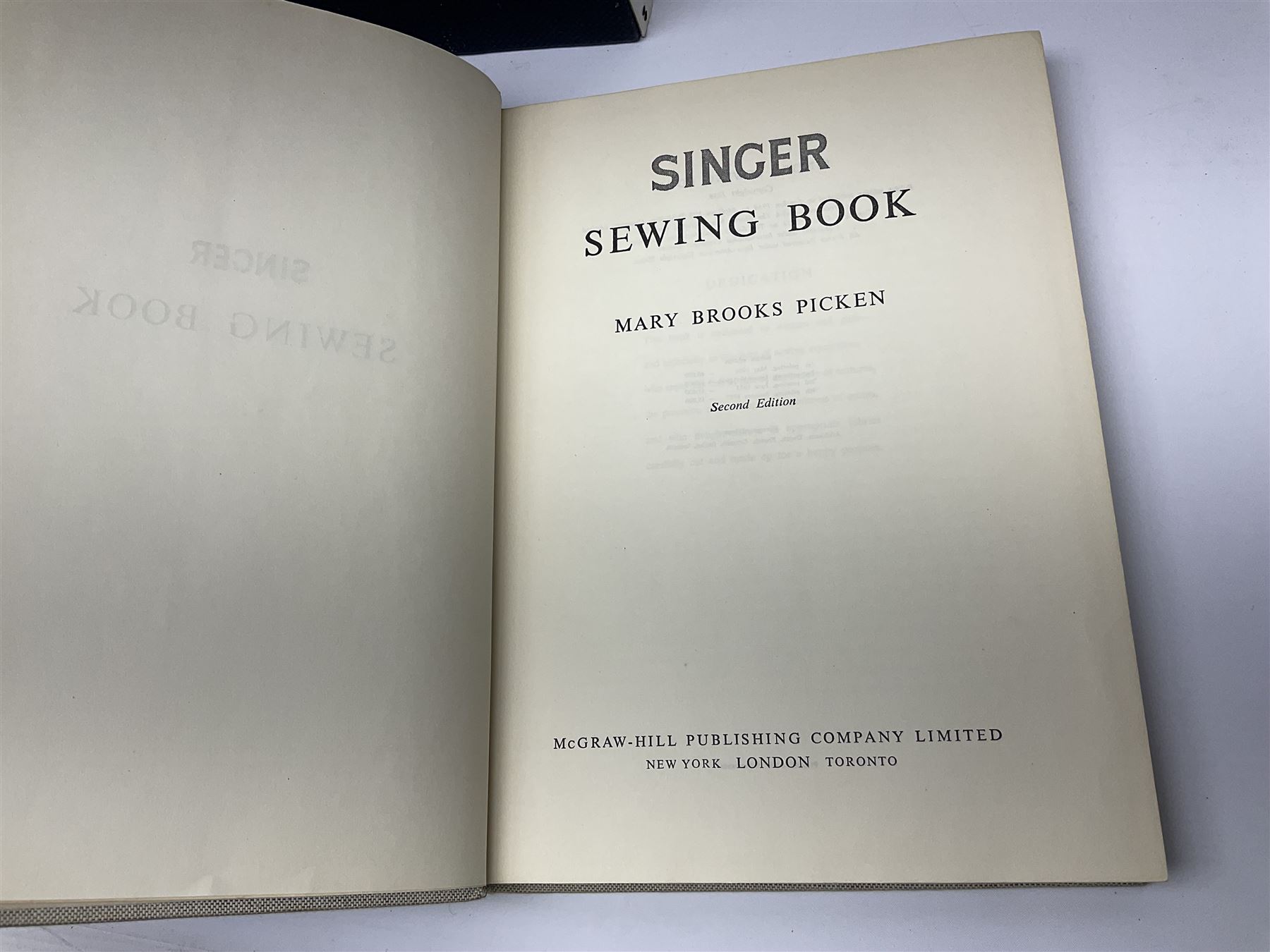 Seamstress sewing machine in case, together with a Singer sewing book