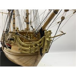 Wooden kit built model of HMS Neptune, 1:90 scale, with detailed rigging to three masts and a row of cannons to either side, upon ebonised wooden base, including stand H71cm