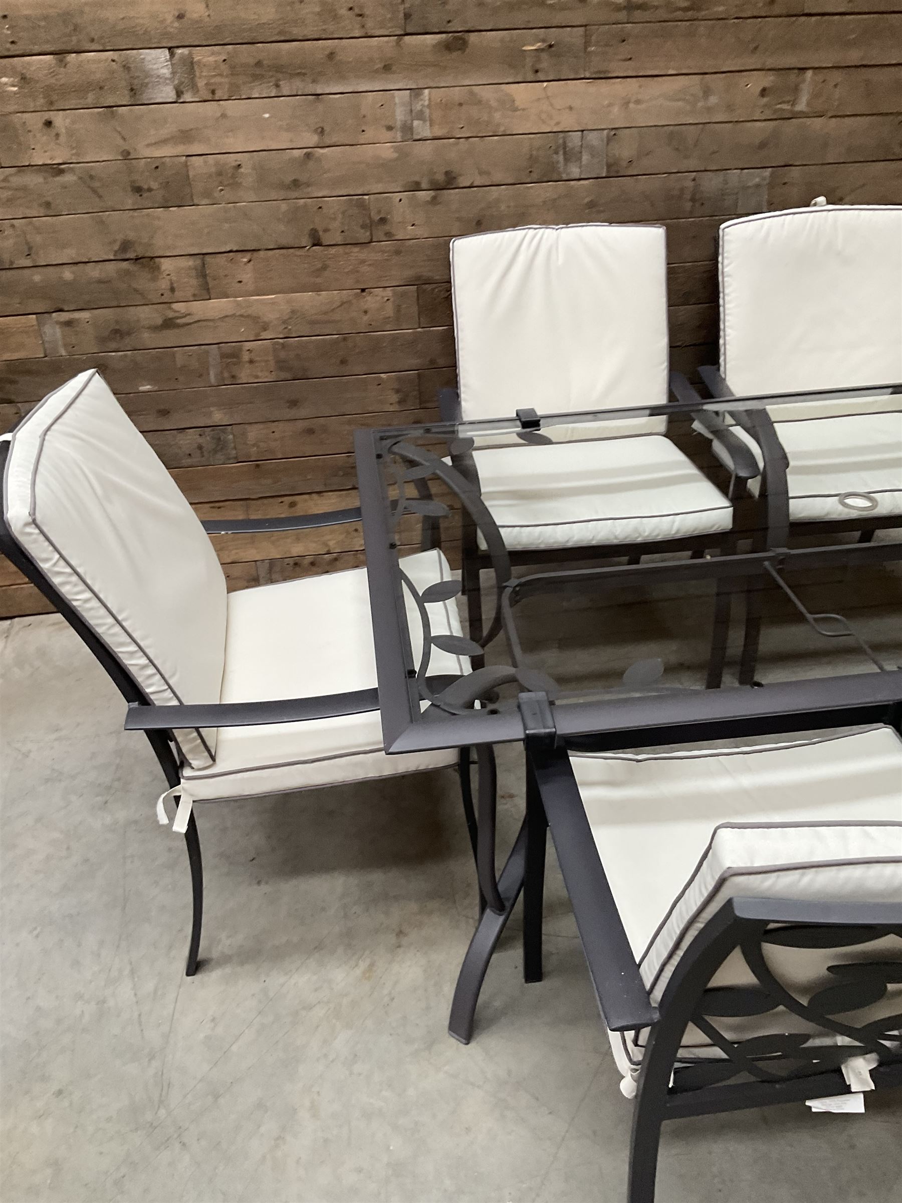 Metal framed garden table with glazed top (W170cm, D102cm, H71cm) and six armchairs with cushions 