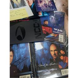 Collection of Star Trek The Next Generation and Deep Space Nine memorabilia, including two limited edition signed Star Trek Deep Space Nine photographs, commemorative porcelain plaque, insignias, Encounter at Farpoint pewter plaque, signed photograph of the Voyager crew, two signed copies of Convergence and a signed War & Madness graphic novel, canvas prints and other signed photos, together with Star Wars Ray Park (Darth Maul) signed photograph, UFO and Buck Rogers memorabilia