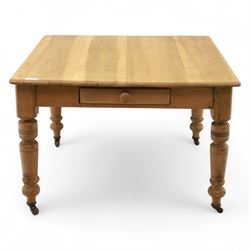 Contemporary pine kitchen table, rectangular top with moulded edge, fitted with single drawer, raised on turned supports with ceramic castors
