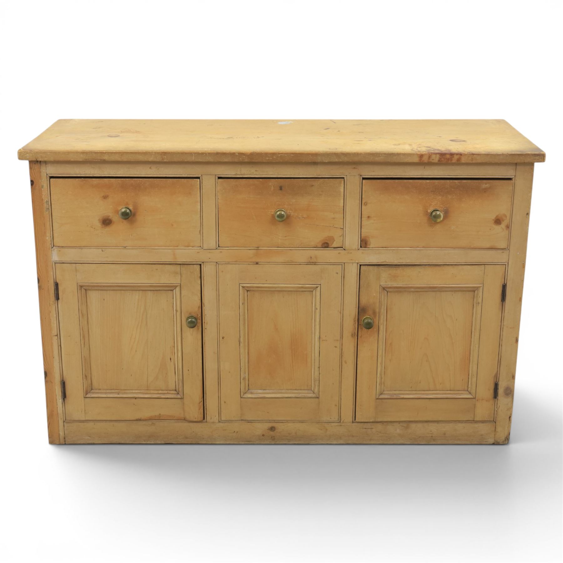 Victorian pine dresser base, with rectangular plank top, above three short drawers over two cupboard doors