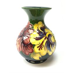 A Moorcroft vase of bulbous form with waisted neck decorated in the hibiscus pattern, with impressed marks beneath, H13cm. 