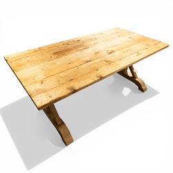 Pine country x-framed dining table, a rustic plank top raised on two x-framed supports