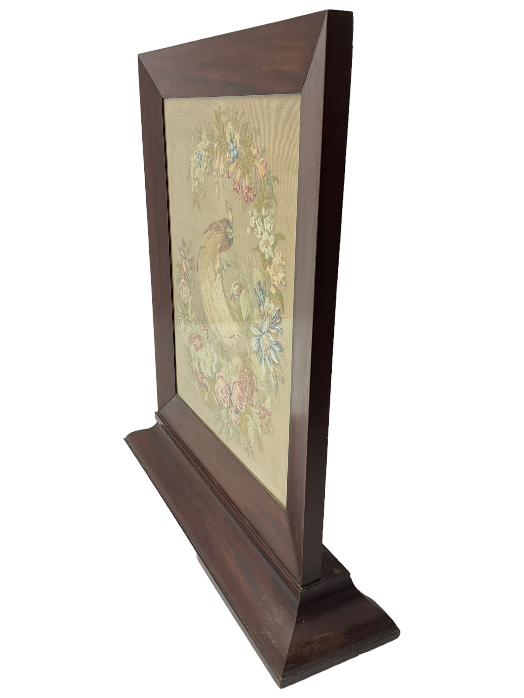 Victorian mahogany fire screen, the tapestry panel depicting peacock and flowers