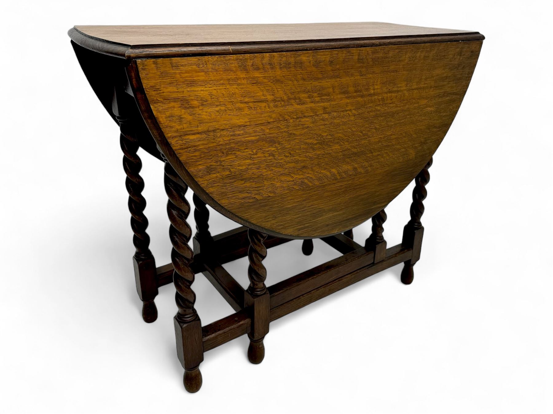 Early 20th century oak gateleg table, oval top with drop leaves supported by barley twist swing supports, united by plain stretchers, on turned feet (W119cm, D92cm, H77cm);