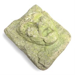 Collection of cast stone garden objects including mill stone, trough, planter, and faces